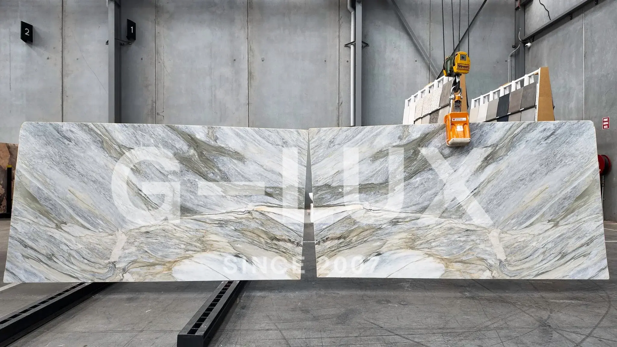 Aardwolf slab lifter gripping a stone slab in a fabrication facility